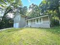 Ranch style home with a covered porch and a lush green lawn at 4550 Cypress Ridge Ct, Stone Mountain, GA 30083