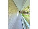 Long front porch with white railings and brick columns at 4550 Cypress Ridge Ct, Stone Mountain, GA 30083