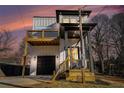 Two-story modern farmhouse at sunset, balcony, and landscaped yard at 862 Hobson Sw St, Atlanta, GA 30310