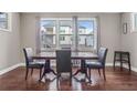 Formal dining room with hardwood floors, large windows, and a table with chairs at 1622 Harvestwood Ct, Hoschton, GA 30548