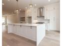 Modern kitchen featuring white cabinetry, a large island, and stainless steel appliances at 550 Fisher Dr # 47, Alpharetta, GA 30009