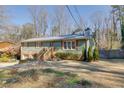 Green Ranch home with mature trees and a large yard at 2500 Cottonwood Dr, Marietta, GA 30066