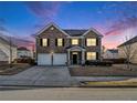 Traditional two-story brick home featuring a two-car garage, well-manicured lawn, under beautiful skies at 2784 Cypress Rdg, Loganville, GA 30052