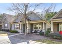 Gray siding home with stone accents, welcoming porch, and landscaping at 340 Glens Way, Woodstock, GA 30188