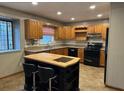 Kitchen with island, wood cabinets, and tile floor at 850 Airline Rd. Rd, Mcdonough, GA 30252