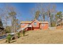 Red siding ranch home with large yard at 180 Paces Lakes Pointe St, Dallas, GA 30157