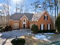 Two-story home with a brick facade and landscaping at 2585 Club Springs Drive, Roswell, GA 30076