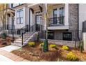 Charming brick townhome with landscaped front yard, entry stairs, and wrought iron railings at 540 Fisher Dr # 46, Alpharetta, GA 30009