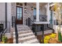 Townhome's front entrance with brick steps and metal railing at 550 Fisher Dr # 46, Alpharetta, GA 30009