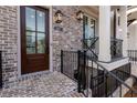 Dark brown front door with glass panes and sidelights at 550 Fisher Dr # 46, Alpharetta, GA 30009