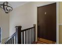 Hallway by the front door features a modern lighting fixture and dark-colored hardwood railings at 708 Argonne Ne Ave # 5, Atlanta, GA 30308