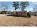 Brick ranch house with a large yard at 8554 Taylor Rd, Riverdale, GA 30274