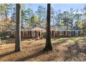 Brick ranch house nestled amongst tall trees at 200 Mcguirts Bridge Rd, Covington, GA 30014