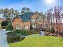 Brick two-story home with landscaping and a paved driveway at 3327 High Noontide Way, Acworth, GA 30101