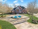Brick home with circular drive and landscaping at 1586 Highway 11 N, Social Circle, GA 30025