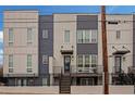 Modern three-story townhome with gray and white siding, deck, and fenced yard at 687 Banton Nw Dr, Atlanta, GA 30318