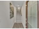 Bright hallway featuring hardwood floors, fresh paint and natural lighting from front door at 3812 Thatcher Sw Dr, Marietta, GA 30008