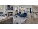 Open concept living room and kitchen features hardwood floors, fireplace and modern accents at 3812 Thatcher Sw Dr, Marietta, GA 30008