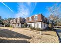 Townhouse building with brown roof and landscaping, sunny day at 113 Rue Fontaine # 113, Lithonia, GA 30038