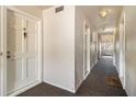 Clean hallway with carpeted floor and doors to units at 113 Rue Fontaine # 113, Lithonia, GA 30038