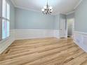 Formal dining room featuring hardwood floors and wainscoting at 215 Deer Cliff, Lawrenceville, GA 30043