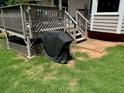 Back deck with stairs and grill, leading to backyard at 208 Hickory Rdg, Cumming, GA 30040