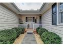 Inviting front porch with white railing and landscaping at 208 Hickory Rdg, Cumming, GA 30040