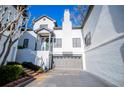 White townhome with gray garage door and brick accents at 4196 Roswell Rd Ne, Atlanta, GA 30342