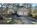 Two-story house with a two-car garage and a small yard at 5674 Wylmoor, Norcross, GA 30093