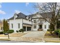 White brick home with a 3-car garage and landscaping at 745 Glengate Pl, Atlanta, GA 30328