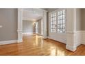 Bright living room featuring hardwood floors, detailed trim and French doors at 745 Glengate Pl, Atlanta, GA 30328