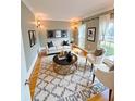 Cozy living room with neutral color scheme, hardwood floors, patterned rug, and natural light at 745 Glengate Pl, Atlanta, GA 30328