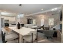 Open concept dining room features a light wood table and chairs, adjacent to the kitchen at 2049 Mcafee Rd, Decatur, GA 30032