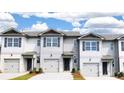 Gray townhouses with white accents and gray garage doors at 2102 Moss Hill Rd, Stone Mountain, GA 30088