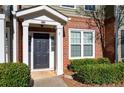 Townhome's front entrance with brick facade and landscaping at 2116 Del Lago Nw Cir # 3, Kennesaw, GA 30152