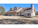Two-story house with brown roof, porch, and detached shed at 5024 Klondike Rd, Lithonia, GA 30038