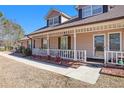 House entrance with porch, white railing, and landscaping at 5024 Klondike Rd, Lithonia, GA 30038