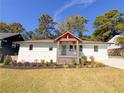 Modern white house with a covered entryway, updated landscaping, and a concrete driveway at 1912 Canmont Ne Dr, Atlanta, GA 30319