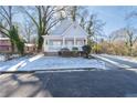 Gray house with white porch and snow-covered lawn at 1156 Tucker Sw Pl, Atlanta, GA 30310