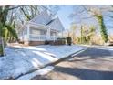 Gray house with white porch, snow on the ground, and trees at 1156 Tucker Sw Pl, Atlanta, GA 30310