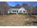 White house with gray roof and landscaping on a hill at 857 Garner Rd, Rockmart, GA 30153
