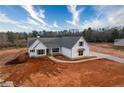 A high angle of the house, revealing the layout of the land and trees surrounding the property at 137 Woodfin Way, Social Circle, GA 30025