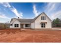 Charming white farmhouse with a well-maintained lawn and inviting front porch at 137 Woodfin Way, Social Circle, GA 30025