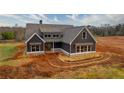 New home featuring board and batten siding, well-placed windows and professional, modern color palette at 181 Woodfin Way, Social Circle, GA 30025