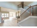 Bright living space with fireplace open to kitchen, featuring an elegant staircase and large windows at 181 Woodfin Way, Social Circle, GA 30025