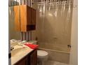 Clean bathroom with tub shower combo and wood cabinet at 3754 Sidney Lanier Blvd, Duluth, GA 30096