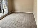 Spacious living room with carpet and a large window letting in natural light at 860 Flat Shoals Rd, Atlanta, GA 30349