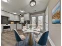 Modern eat-in kitchen with white cabinets, a breakfast bar, and French doors leading to the deck at 445 Milton Dr, Canton, GA 30114