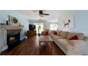 Spacious living room with hardwood floors, fireplace, and large windows at 230 Bennett Farms Trl, Acworth, GA 30102