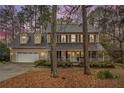 Charming two-story traditional home boasts a 2-car garage and inviting front porch with black shutters at 515 Lees Sw Trce, Marietta, GA 30064